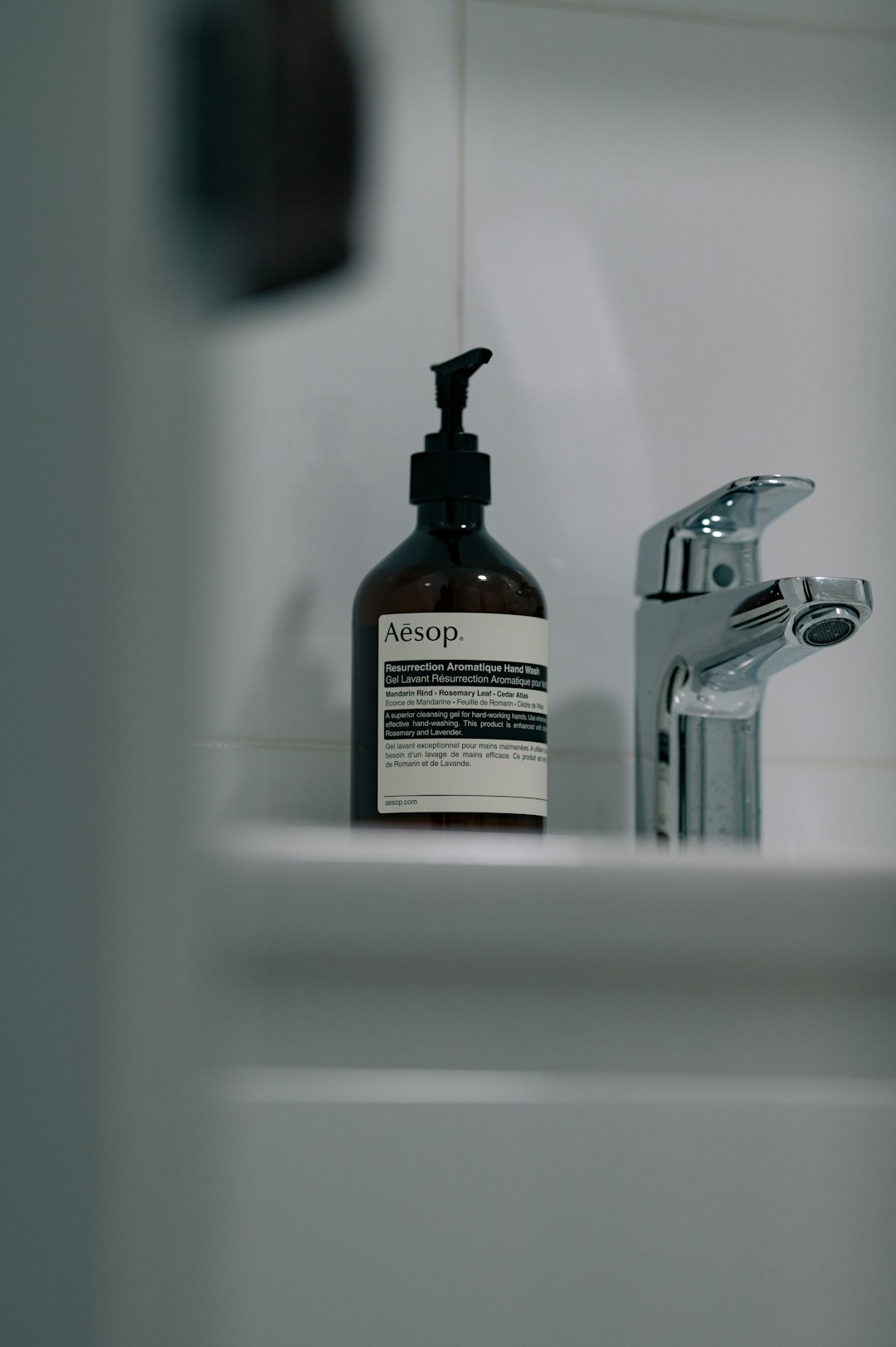 why-choose-us aesop-hand-soap-bottle-next-to-a-chrome-faucet-lswyprnfh0s